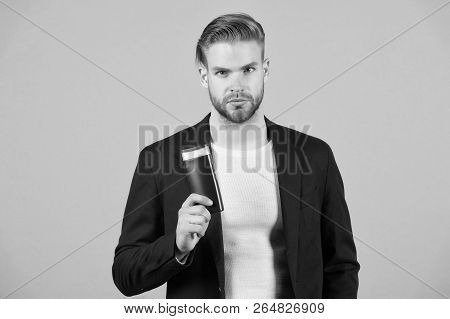 Confident In Hair Care Product. Man Stylish Hairstyle Holds Bottle Hygienic Product Grey Background.