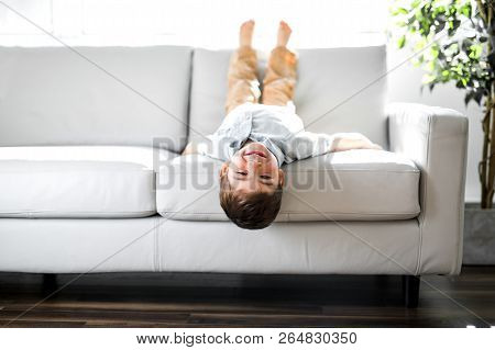 Young Boy Relaxing On Sofa At Home