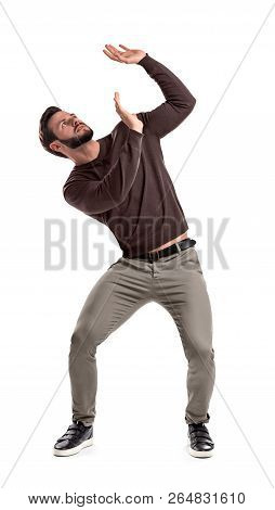 A Bearded Man In Casual Garb Stands Protecting Himself With Outstretched Hands From Something Gettin