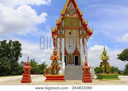 Front View Of The Red And White Temple With The Guards And Steps Leading To The Main Idol Inside At 