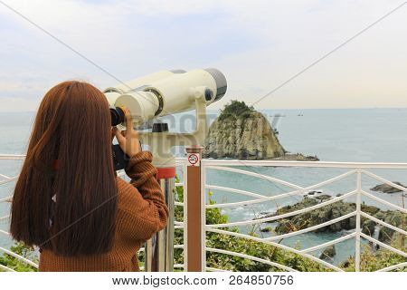 Binoculars. Young Girl Use Binocular Looking To The Island View At Oryukdo Islands In Busan, South K