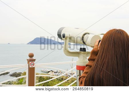 Binoculars. Young Girl Use Binocular Looking To The Island View At Oryukdo Islands In Busan, South K