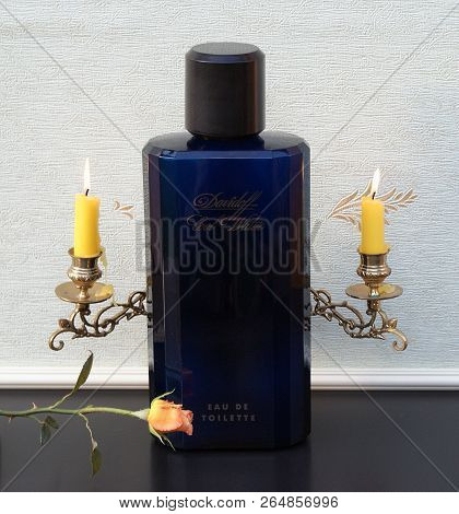 Davidoff Cool Water, Eau De Toilette, Large Perfume Bottle In Front Of A Piano Candelabra With Shini