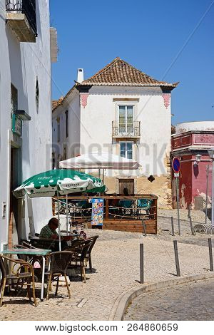 Tavira, Portugal - June 12, 2017 - People Relaxing At Pavement Cafes Along R Concalo Velho In The Ol
