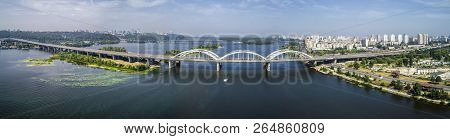 Aerial Panorama View Of Automobile And Railroad Darnitsky Bridge Across Dnieper River From Above, Ki