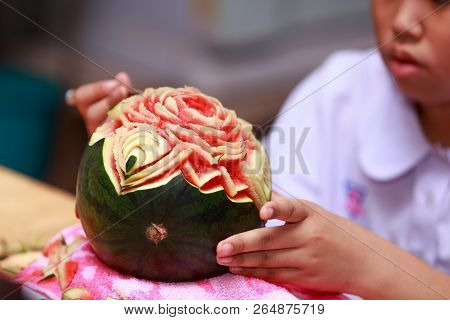 Asian Little Girl Carve Fruit In School
