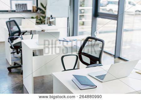 Laptop On Tables In Empty Modern Office