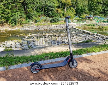 Geoje, South Korea - October 14, 2018 : Ninebot By Segway Es2 Kickscooter Park Near The Small Canal 