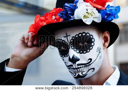 A Man With A Painted Face Of A Skeleton, A Dead Zombie, In The City During The Day. Day Of All Souls