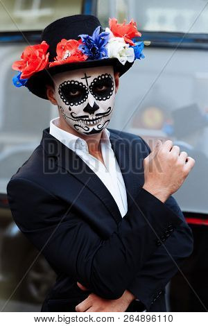 A Man With A Painted Face Of A Skeleton, A Dead Zombie, In The City During The Day. Day Of All Souls