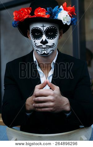 A Man With A Painted Face Of A Skeleton, A Dead Zombie, In The City During The Day. Day Of All Souls