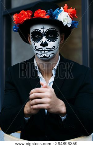 A Man With A Painted Face Of A Skeleton, A Dead Zombie, In The City During The Day. Day Of All Souls
