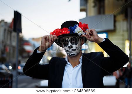 A Man With A Painted Face Of A Skeleton, A Dead Zombie, In The City During The Day. Day Of All Souls