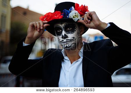 A Man With A Painted Face Of A Skeleton, A Dead Zombie, In The City During The Day. Day Of All Souls