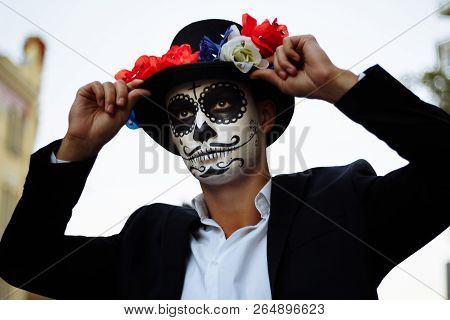 A Man With A Painted Face Of A Skeleton, A Dead Zombie, In The City During The Day. Day Of All Souls