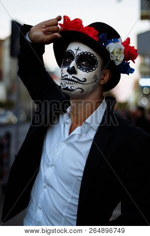 A Man With A Painted Face Of A Skeleton, A Dead Zombie, In The City During The Day. Day Of All Souls