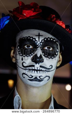 A Man With A Painted Face Of A Skeleton, A Dead Zombie, In The City During The Day. Day Of All Souls