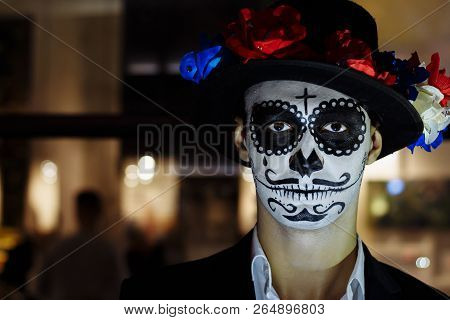 A Man With A Painted Face Of A Skeleton, A Dead Zombie, In The City During The Day. Day Of All Souls