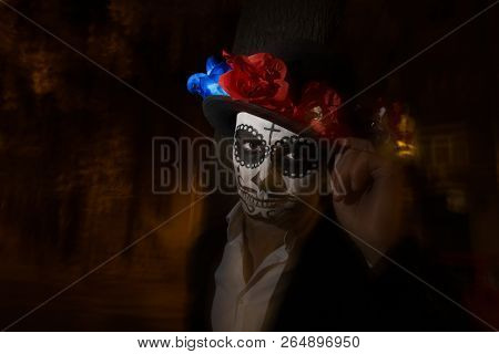 A Man With A Painted Face Of A Skeleton, A Dead Zombie, In The City During The Day. Day Of All Souls