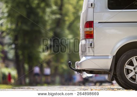 Close-up Side View Detail Of Silver Passenger Medium Size Luxury Minibus Van With Tow-bar Parked On 