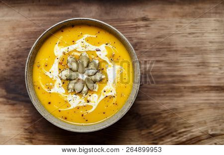 Vegetarian Pumpkin Cream Soup. Autumnal Pumpkin Soup. Home Made Pumpkin Cream Soup Decorated With Cr