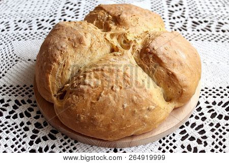 Homemade Baking. Splendid Ruddy White Flour Bread On A Wooden Stand On The Background Of Handmade Ha