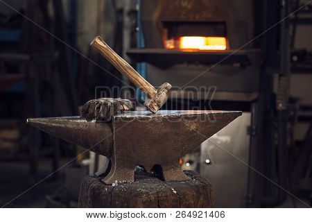 Mallet And Gloves On An Anvil In Front Of A Furnace