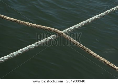 Two Hennep Fiber Ropes Crossing Eachother In The Middle With A Ocean Water Background