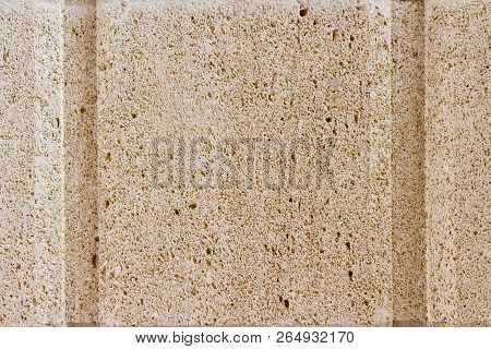 A Very Highly Detailed Light Pink Backgroun With 2 Verticle Lines Carved Into The Stone.