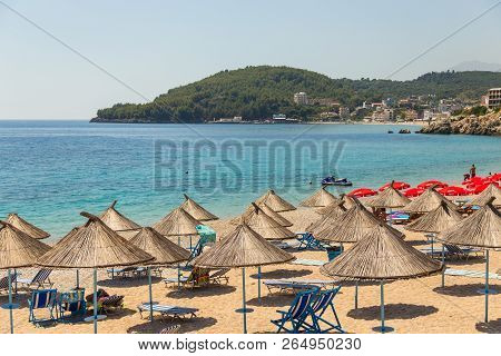 Himare, Albania- 29 June 2014: Sunbathers On The Beach In Himare Resort. Stony Beach On The Adriatic