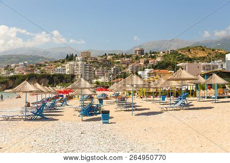 Himare, Albania- 29 June 2014: Sunbathers On The Beach In Himare Resort. Stony Beach On The Adriatic