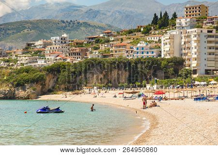 Himare, Albania- 29 June 2014: Sunbathers On The Beach In Himare Resort. Stony Beach On The Adriatic