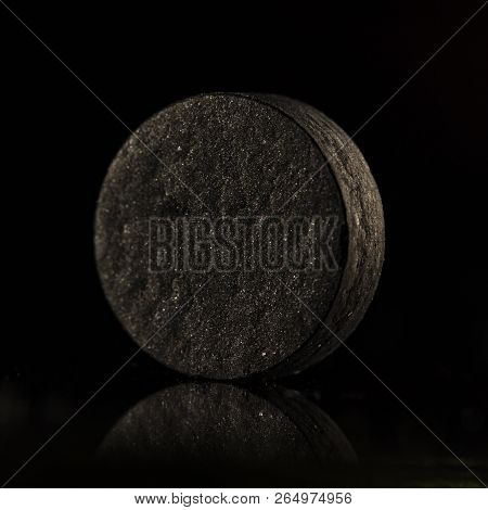 Medical Drug, Black Tablet Activated Carbon On A Black Background In Backlight