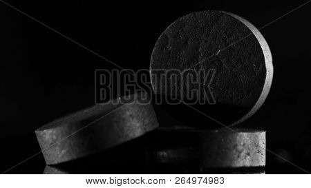 Medical Drug, Black Tablet Activated Carbon On A Black Background In Backlight