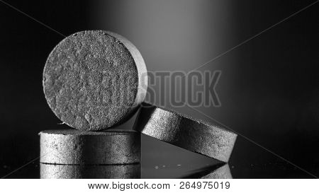 Medical Drug, Black Tablet Activated Carbon On A Black Background In Backlight
