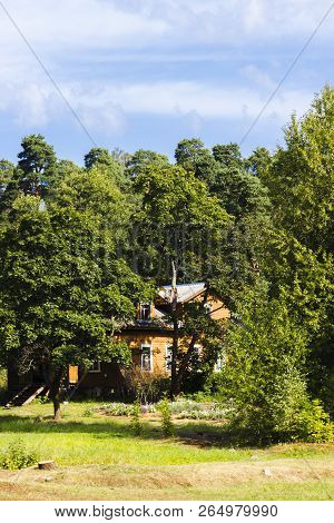 Wooden House In The Forest Among The Trees