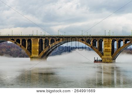 Francis Scott Key Bridge Across Potomac River, Winter Fog On The Water.