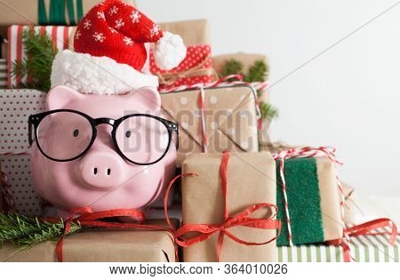Piggy Bank And A Lot Of Gift Boxes. Christmas Decor. White Background. Fir Branches.