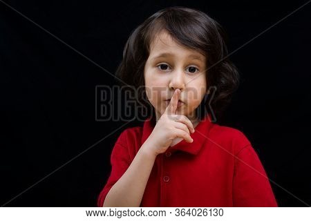 Cute  Kid Put Index Finger Over Lips For  Quiet Gesture