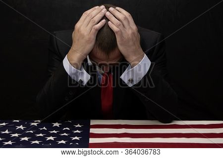The Man Was Leaning Over A Coffin Covered In An American Flag, His Head In His Hands. He May Have Lo