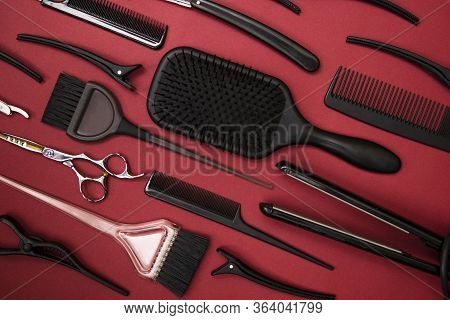 Combs And Hairdresser Tools On Red Background Top View
