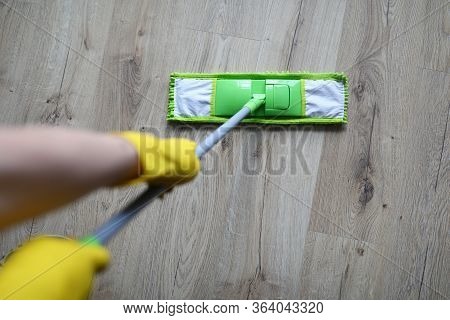 Top View Of Person Hands In Hands Holding Mop And Cleaning Floor. Tools For Cleaning. Microfiber Flu