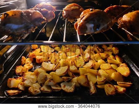 Closeup Of Fried Chicken Legs With Potato Chips Baked In Oven. Appetizing Roast Turkey. Delicious Me