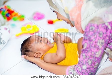 A Mother And A Six Month Age Baby Boy Enjoying Their Time.