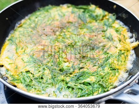 Omelet In Cha Om While The Oil Is Boiling Cha-om Is A Pungent Vegetable.high Nutritional Value