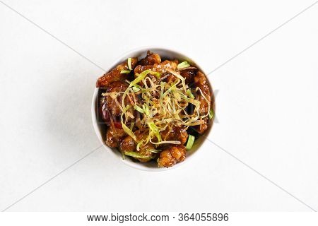 Spicy Garlic Fried Chicken (kkanpunggi). Asian Chicken In Sweet And Sour Sauce In Bowl Over White Ba