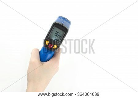 Digital Non-contact Thermometer Gun In Hand Isolated On White Background Top View With Copy Space. I