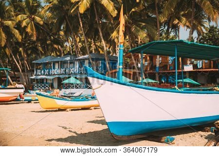 Canacona, Goa, India. Sightseeing Tourist Boat Parked On Famous Palolem Beach In Summer Sunny Day.