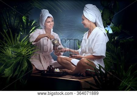 Portrait Of Young Beautiful Women Drinking Tea  In Spa Environment.