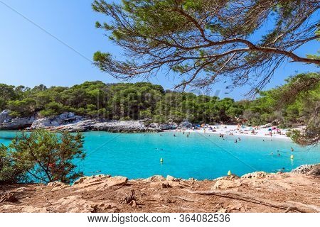 View Of The Famous Beach Cala Turqueta. (focus On Foreground, People On The Beach In Blur). Menorca,